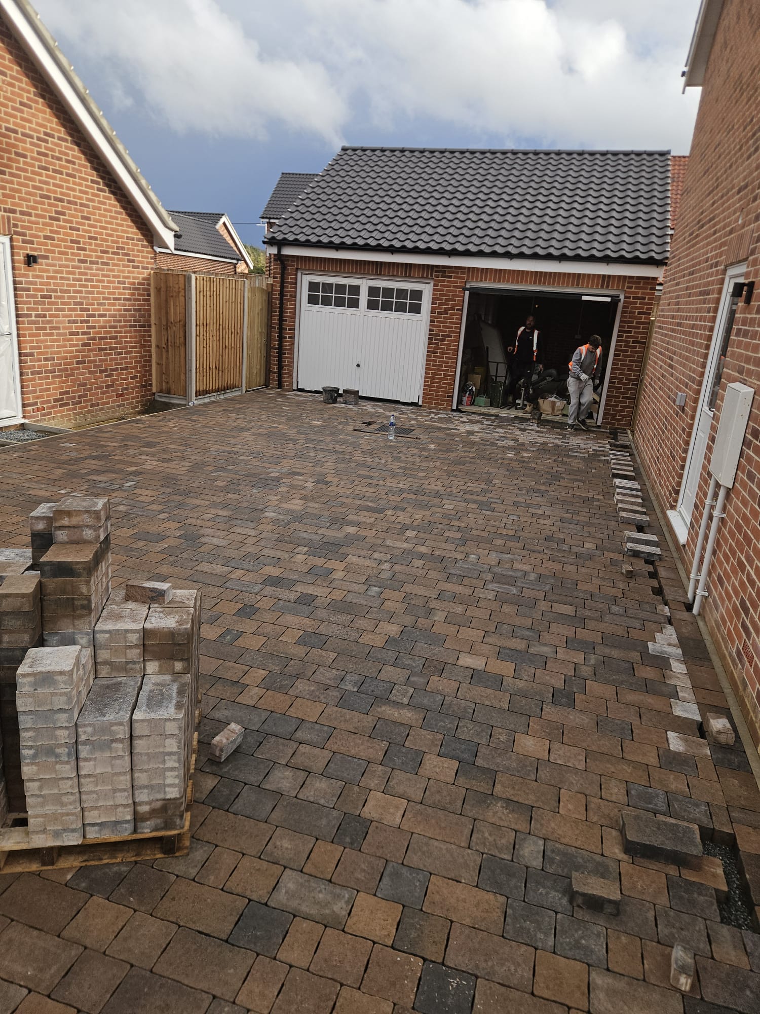 Block paved driveway on sloped site