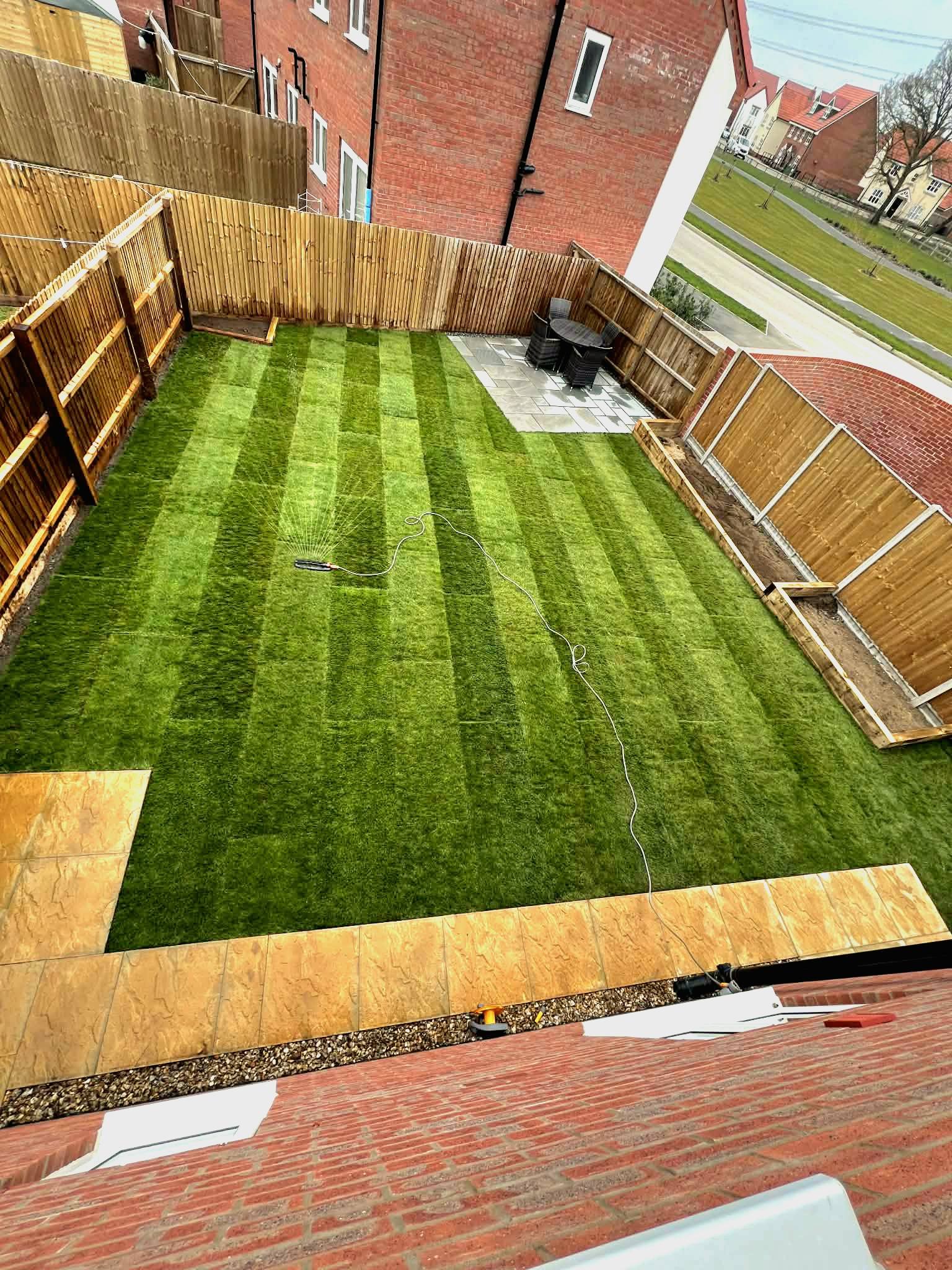 Hethersett garden transformation — sandstone patio, sleeper beds and fresh turf
